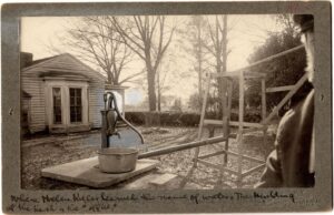 This is an AFB HK Archive photo, and it has been "shopped" with black, grey, and white paint - an extremely common thing to be done to photographs for newspaper and other publications to improve clarity. The 1887 picture shows THE original pump. The 1887 photo is absolutely in the same geographic place in front of the office that the "shed pump" now stands. The picture was taken when Helen was 7 - the photography studio seal and man visible on the side date it well.