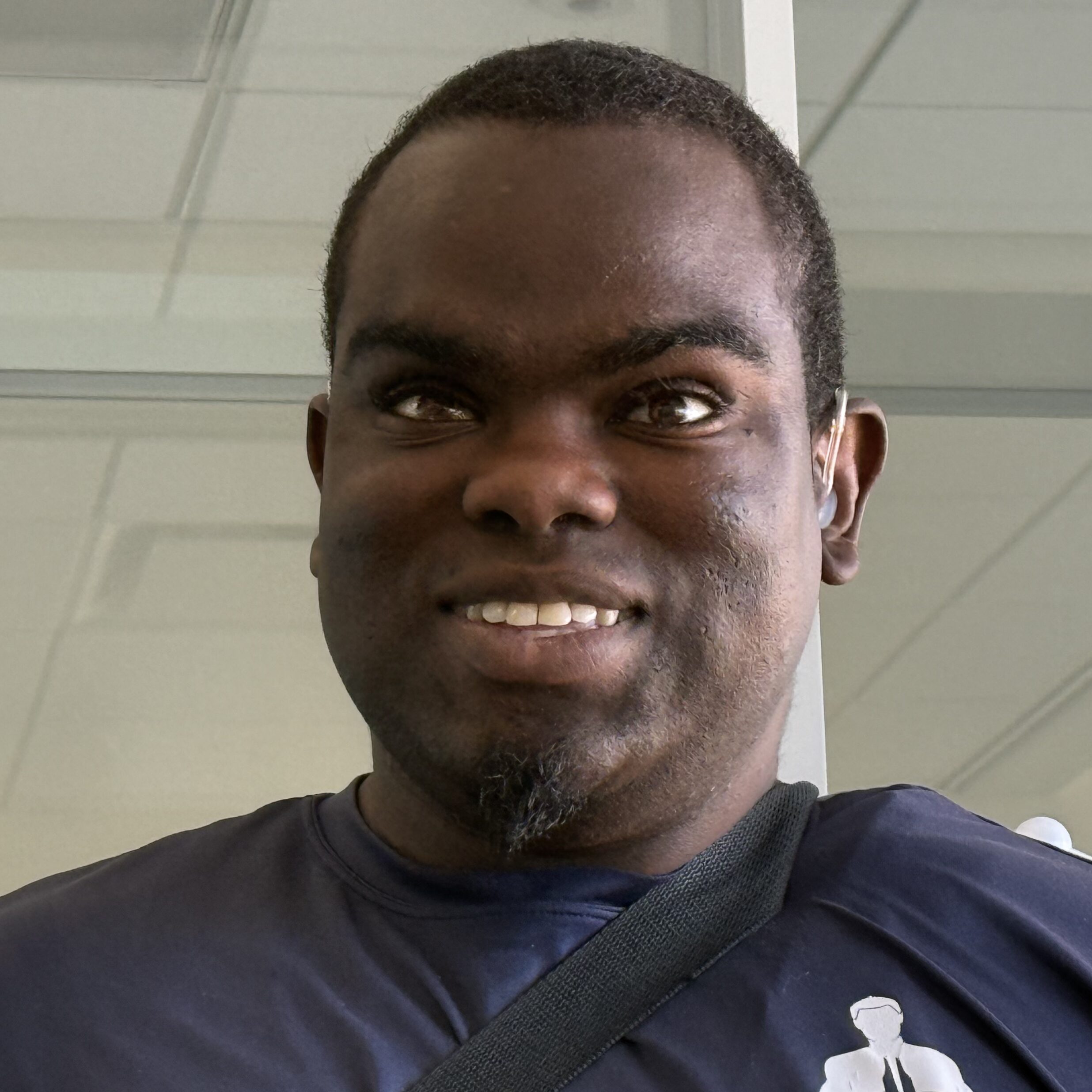 A close up photo of George, smiling at the camera.