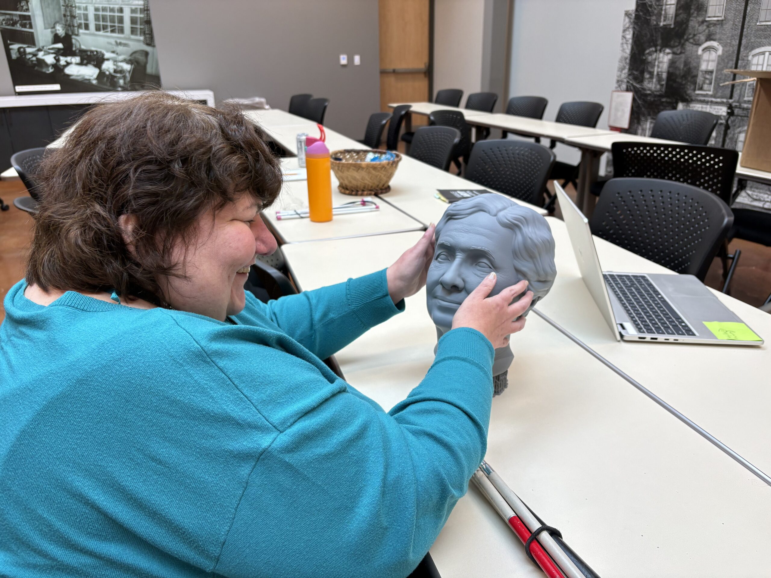 Natalie Couch inspects the prototype of the head of the tactile Helen Keller sculpture.