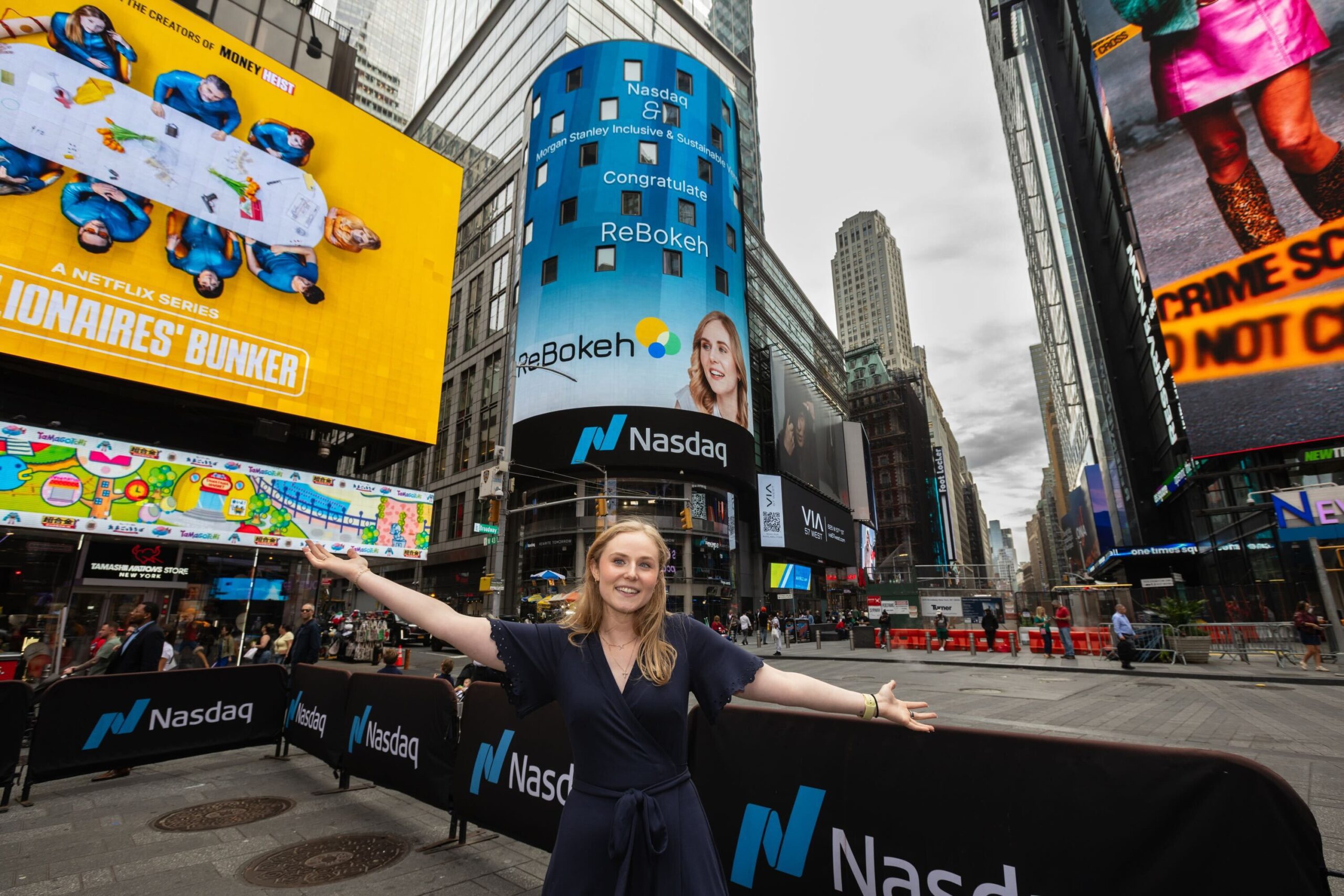 Rebecca stands in front of a digital ReBokah billboard in Times Square.